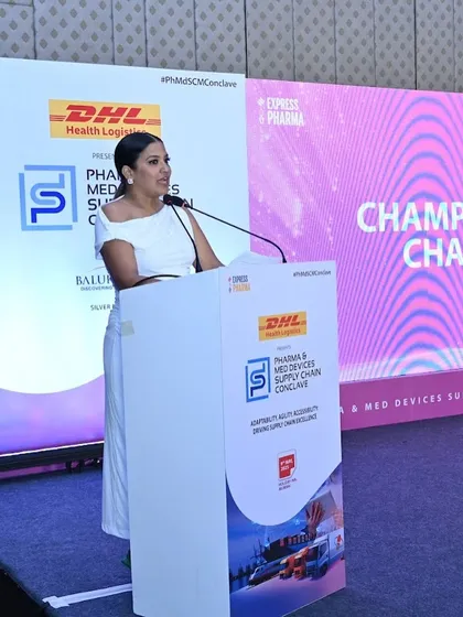 Presenting at the Pharma & Med Devices Supply Chain Conclave, with the theme of "Championing Change" visible.