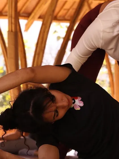 I offer hands-on adjustments during retreats to help students safely deepen their practice. Here, I am assisting a student in Parivrtta Janu Sirsasana, ensuring she gets the maximum benefit from the side-body stretch.