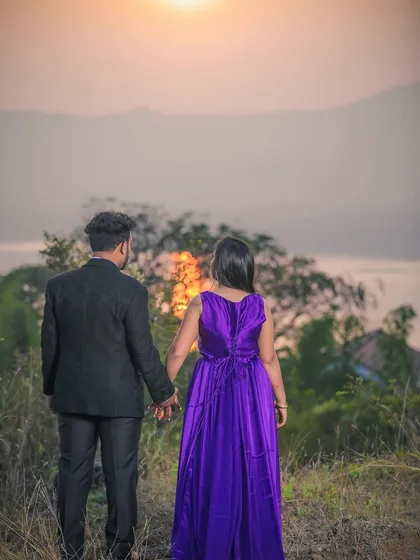 A couple holding hands while watching the sunset over the hills. I seek out beautiful landscapes for pre-wedding shoots that add a sense of wonder and romance.