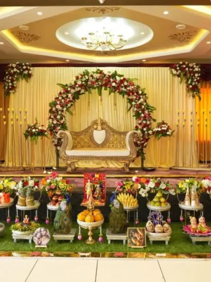 A wide view that captures both the stage and the impressive Seer Thattu display in front of it. This shows how the two elements work together to create a complete decorative theme.