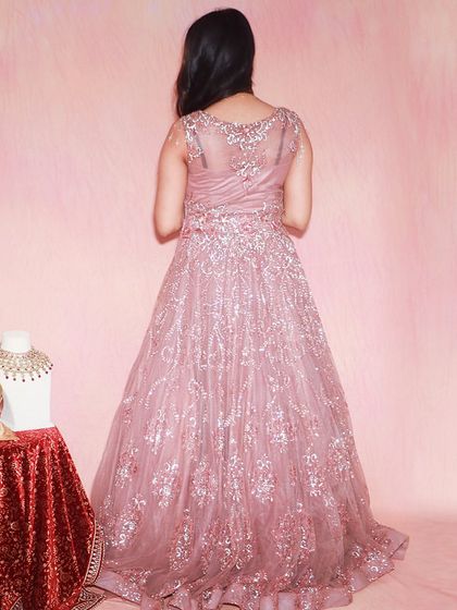 A view of the back of this exquisite pink ball gown, showing the detailed embroidery and the way the fabric drapes. It's stunning from every angle.