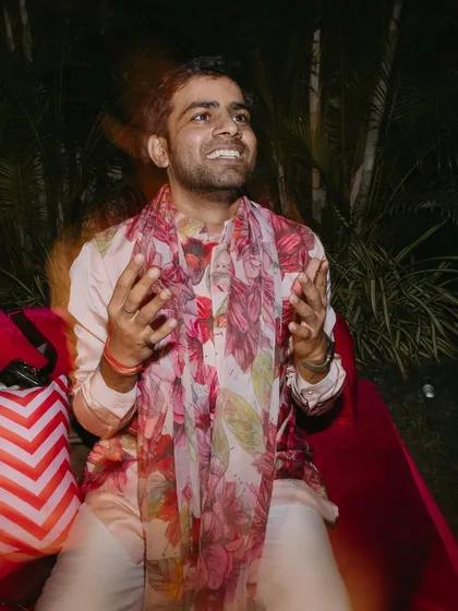 A candid shot of the groom enjoying his sundowner mehendi. I styled him in this fun and floral jacket kurta set with a long scarf, a perfect choice for a vibrant and electric daytime event.