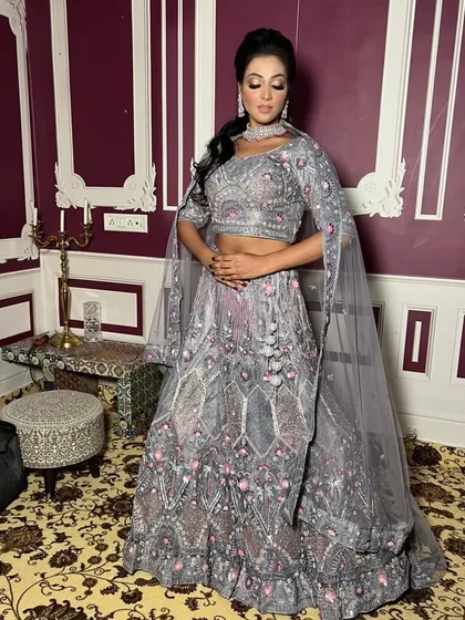 This client strikes a pose in her beautiful grey rental lehenga, a sophisticated and unique choice for a wedding reception or engagement party.