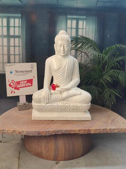 Our 2.5-foot Bhumisparsha Mudra Buddha idol, displayed on a natural stone table. This posture, "touching the earth," represents the moment of enlightenment.