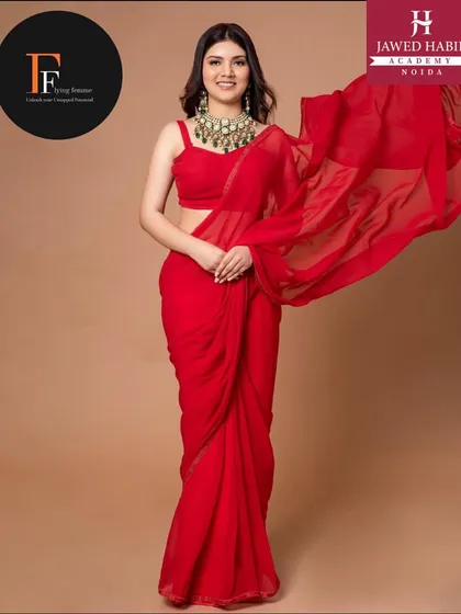 A model in a flowing red saree from a professional fashion shoot. Our students gain real world experience by working on shoots like this.