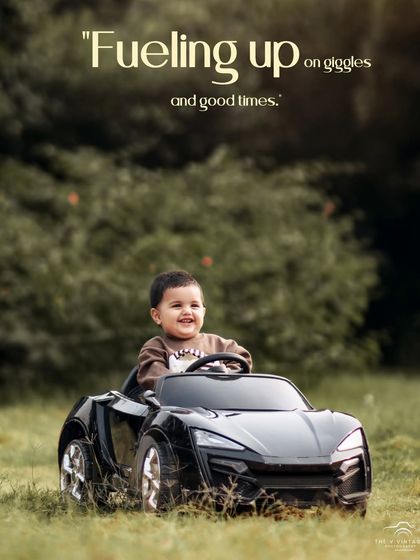 Fueling up on giggles and good times. This happy boy is having a blast driving his toy car through the grass.
