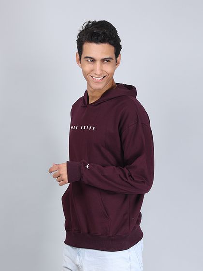 A smiling, three-quarter pose that gives the brand a friendly and approachable feel while showcasing the hoodie.