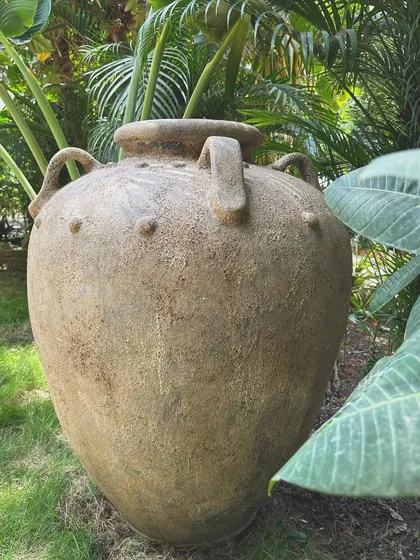 A close-up of the 'Gentong' planter, showing the hand-finished texture and traditional handles. This piece is designed to elevate your outdoor spaces with its commanding presence and beauty.