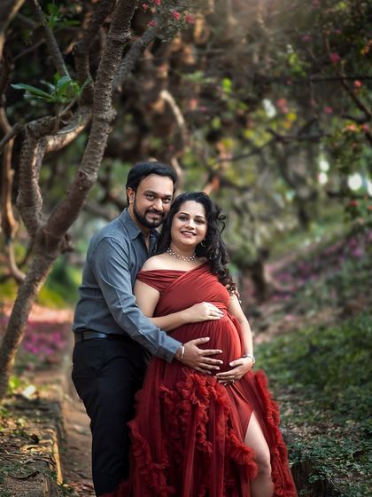 A classic portrait pose, with the partner embracing the mother-to-be from behind, creating a sense of love and security.