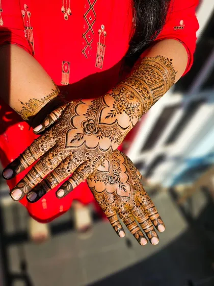 A crossed-hands pose to show the symmetry and detail of the design.