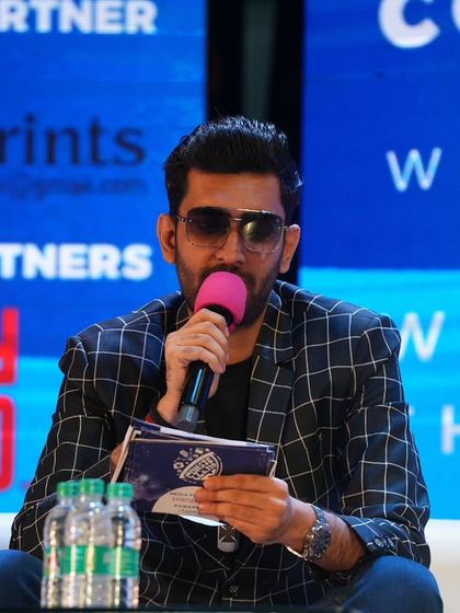 Focused and ready to moderate. A close-up of me at the Constellation Media Conclave, script in hand.