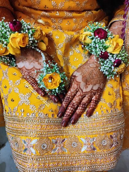 The combination of fresh floral jewelry and a deep henna stain is always a winner. Here is a close-up of the bride's hands during her mehendi ceremony.