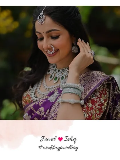 A beautiful smile from a happy bride. For this modern Marathi wedding look, we chose an all-diamond set with emerald accents to pair with her traditional Nauvari saree, creating a fresh and elegant style.