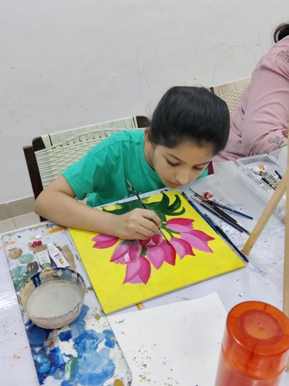 Watch the step-by-step process as a student paints a bright and cheerful bouquet of tulips on a yellow background.