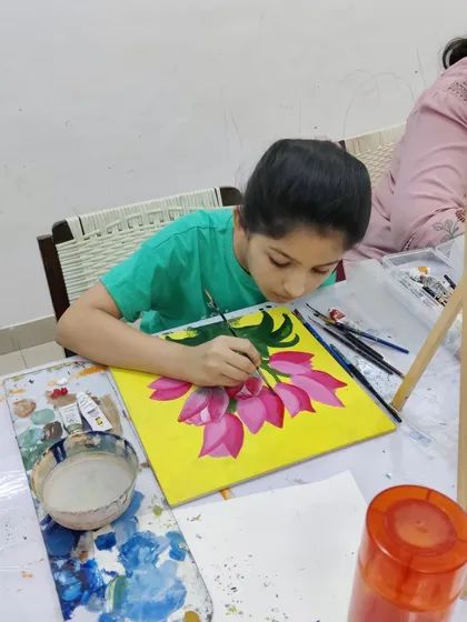 Watch the step-by-step process as a student paints a bright and cheerful bouquet of tulips on a yellow background.