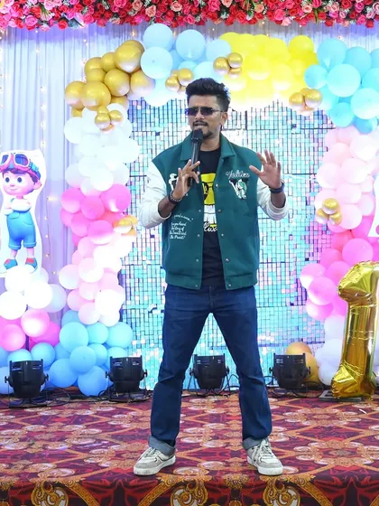 Another shot of me hosting a first birthday party, engaging with the little ones and their parents.