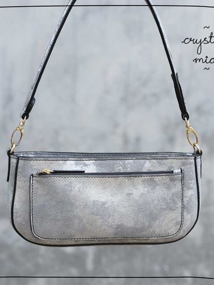 The Mia baguette in our Crystal leather. This was a very special foiled leather with a distressed, metallic silver finish. It was soft and easy to work with, but like many of our upcycled leathers, it was a limited lot and is now sold out.