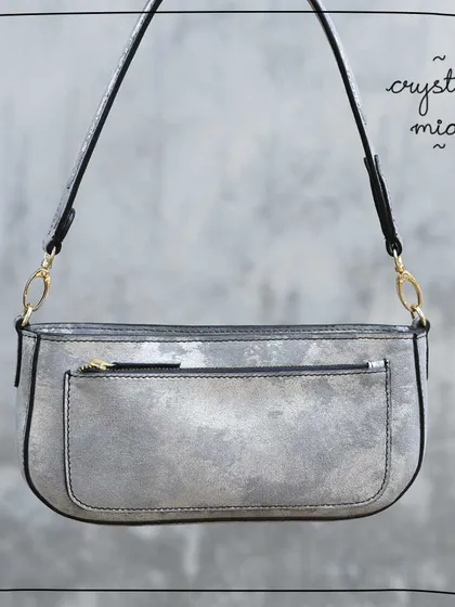 The Mia baguette in our Crystal leather. This was a very special foiled leather with a distressed, metallic silver finish. It was soft and easy to work with, but like many of our upcycled leathers, it was a limited lot and is now sold out.