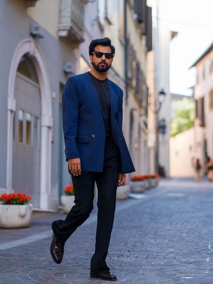 The unique silhouette of the lapel-free blazer makes it a standout piece.