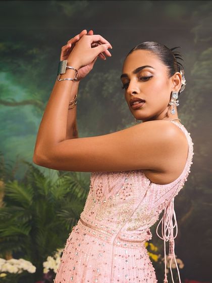 A close-up of the Celine Gown's bodice, showing the delicate ombre embellishments and the elegant tie-back detail for a customized fit.