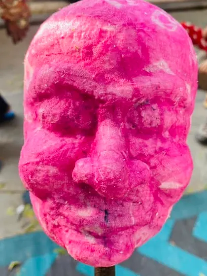 A close-up of a finished papier-mâché head. The texture is rough and full of character before any paint is even applied. This method allows for a lot of creativity in the final look.