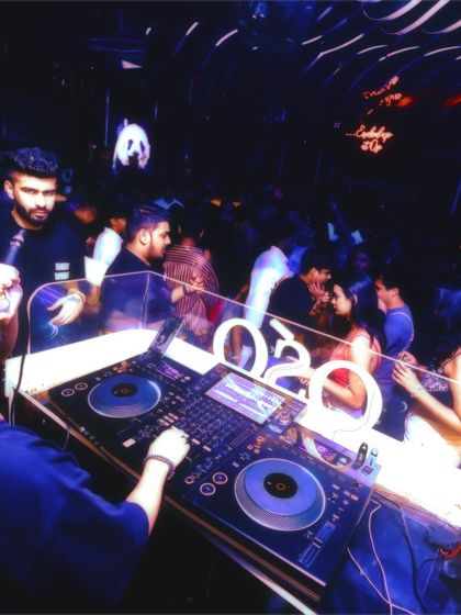 An over the shoulder view of me DJing for a full house. You can see the crowd enjoying themselves right in front of the console.