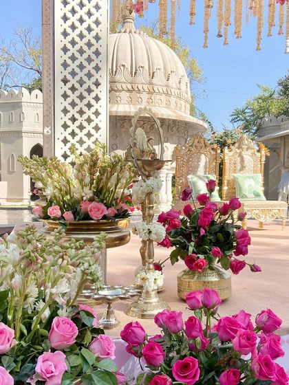 Another angle of the mandap details, showing the beautiful contrast between the hot pink roses, white tuberoses, and the golden brass accessories.
