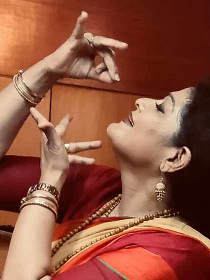 A profile shot capturing the intricate hand gestures and facial expressions that are central to a Bharatanatyam lec-dem.