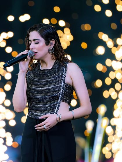 Jonita Gandhi delivers a mesmerizing vocal performance, framed by a cascade of golden lights. We ensure every artist looks and sounds spectacular.