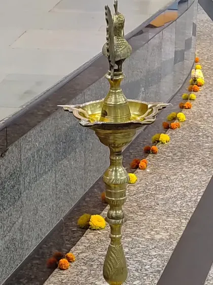 The traditional brass lamp, or samai, decorated with flowers before our celebration. Lighting the lamp is a sacred ritual for us, symbolizing the dispelling of darkness and the welcoming of knowledge.
