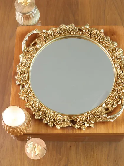 Our round mirror tray with an ornate, rose-bordered gold frame. This romantic and elegant piece is perfect for creating a beautiful display on a dresser or coffee table.