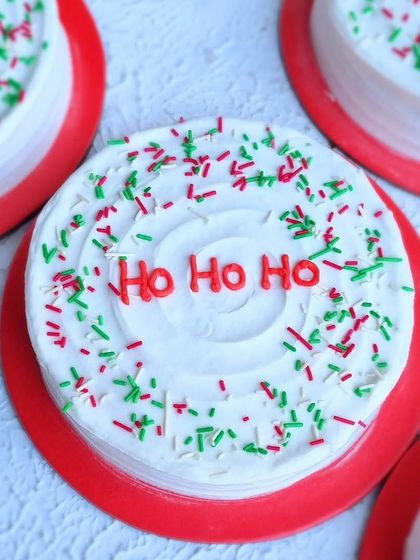 A mini Christmas cake with "Ho Ho Ho" piped in red and festive sprinkles. These make great gifts or individual desserts.