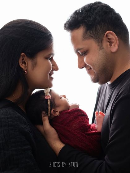A beautiful backlit portrait of a new family. The soft light creates a halo effect, adding a dreamy, angelic quality to this intimate moment.