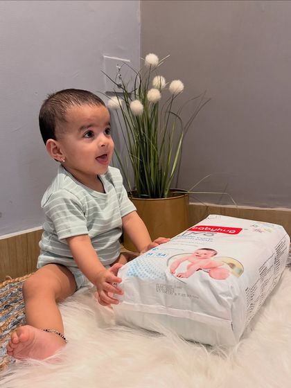 This is a static post from a collaboration with Firstcry for Babyhug Pro Diapers. I clearly list the product's key features like the Shea Butter layer and 12-hour LeakGuard, showing Gauri happily sitting with the product to create a positive association.