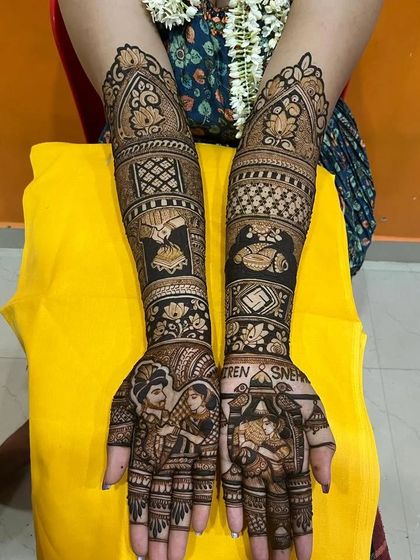 A beautiful design for a Sindhi wedding, featuring portraits of the couple and symbols from the ghari puja ceremony.