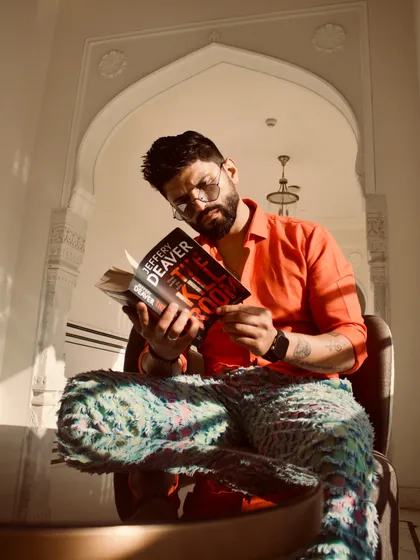 Even when 'reading', I keep it stylish. A posed shot with a book, showing off the full, colorful outfit.