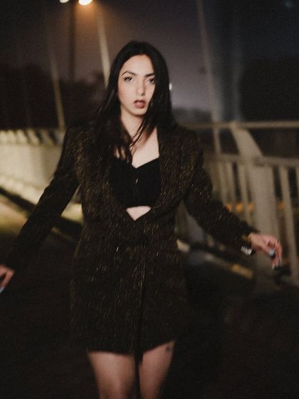 The stars come out when it is dark enough. This is from a moody night shoot on a bridge, creating a dark and atmospheric fashion story.