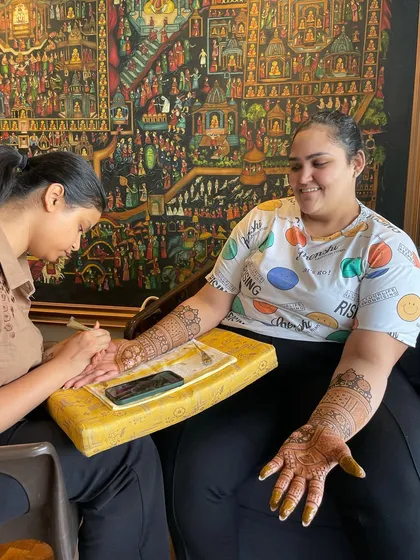 A behind-the-scenes shot of me applying bridal mehendi. It's a process that takes hours, but it's filled with conversation and creativity.