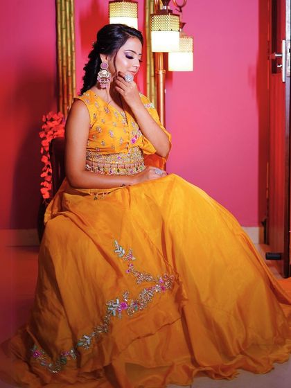 An elegant seated pose in our vibrant yellow lehenga.