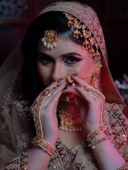 The veil shot adds an element of mystery and highlights the captivating eye makeup.
