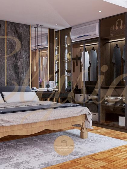 A different perspective of the lavish bedroom with glass wardrobes, highlighting the custom dressing table area with pendant lighting and a plush ottoman. The design balances dark, moody tones with reflective surfaces and warm light.