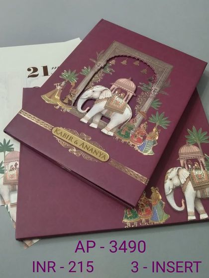 This rich burgundy invitation features a 3D cutout of a royal elephant carrying a howdah. The design is framed by a traditional arch and includes three inserts for all your wedding functions.
