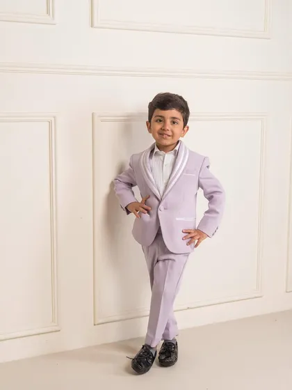 To offer a fresh alternative to traditional colors, I designed this lilac tuxedo. It features a contrasting white shawl collar, making it a standout designer suit for boys attending a summer wedding or a special party.