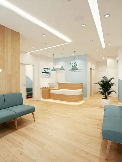 A bright and cheerful clinic waiting area with light wood floors and blue sofas. The design uses geometric shapes and a mix of materials to create a modern and friendly atmosphere.
