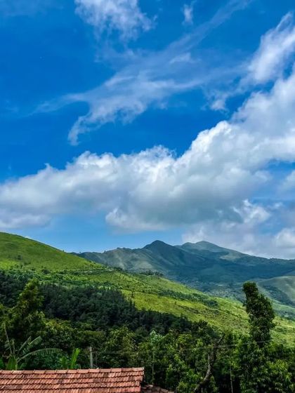 A stunning view of the green hills and blue sky from our homestay in Chikmagalur.