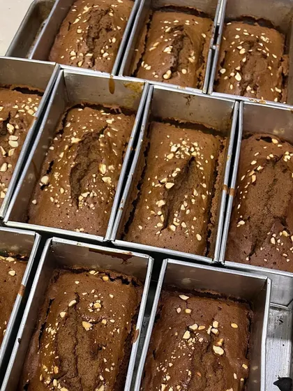 Freshly baked mini loaf cakes cooling in their tins. This is where the magic begins. The aroma in the bakery during the holiday season is just incredible.