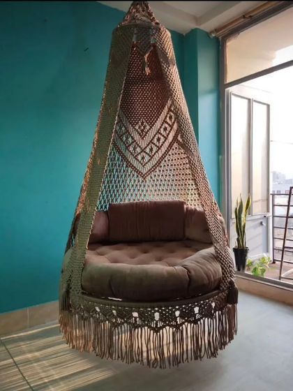 Our single seater swing placed on a balcony with a city view. It’s a perfect way to create a small, personal oasis even in an urban apartment.