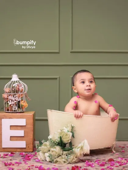 Another angle from the lovely first birthday milk bath shoot, showing the beautiful details of the setup with floral birdcages and wooden 'ONE' blocks.
