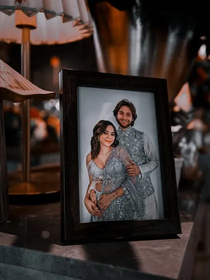 A framed photo of the couple adds a personal touch to the Mehndi decor, reminding everyone of the love story at the center of the celebration.