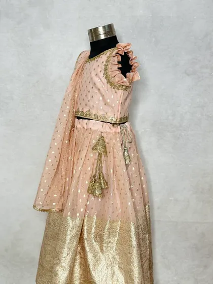 A side view of the periwinkle lehenga, showing the flutter sleeves and the flow of the skirt.